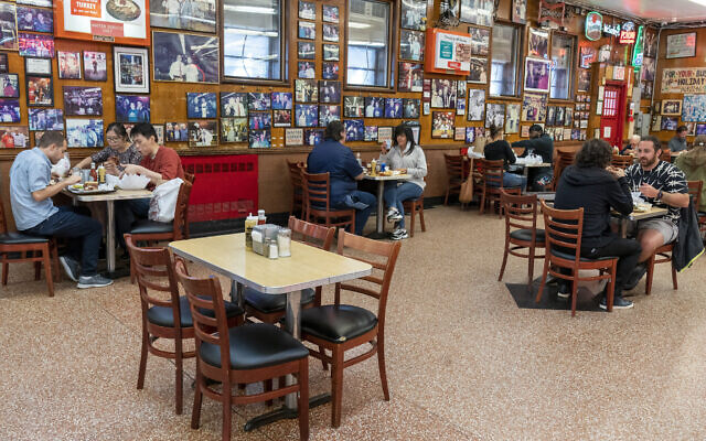 In this September 30, 2020, file photo, tables are spaced allowing for proper social distancing as customers enjoy lunch indoors at Katz's Delicatessen in New York. (AP/Mary Altaffer, File) In this September 30, 2020, file photo, tables are spaced allowing for proper social distancing as customers enjoy lunch indoors at Katz's Delicatessen in New York. (AP/Mary Altaffer, File)