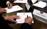 Members of the Mississippi Electoral College sign certificates of votes in the process of formally casting their electoral votes in the 2016 US presidential elections, at the Capitol in Jackson, Mississippi, December 19, 2016. (AP Photo/Rogelio V. Solis, File)
