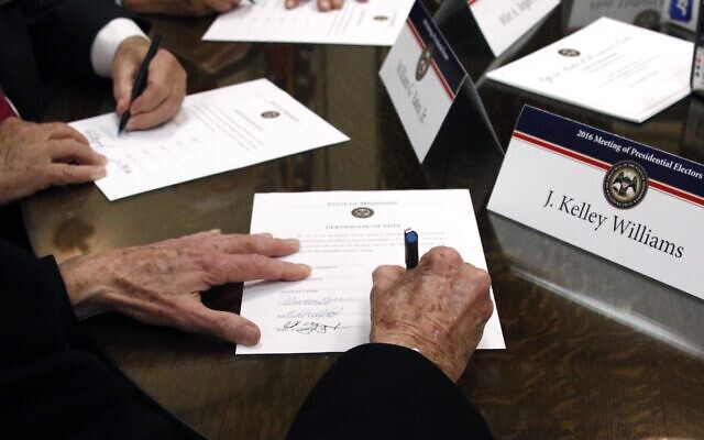 Members of the Mississippi Electoral College sign certificates of votes in the process of formally casting their electoral votes in the 2016 US presidential elections, at the Capitol in Jackson, Mississippi, December 19, 2016. (AP Photo/Rogelio V. Solis, File) Members of the Mississippi Electoral College sign certificates of votes in the process of formally casting their electoral votes in the 2016 US presidential elections, at the Capitol in Jackson, Mississippi, December 19, 2016. (AP Photo/Rogelio V. Solis, File)
