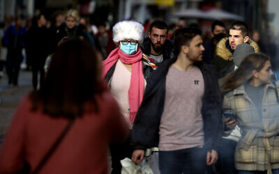 Christmas shoppers in Oxford city centre  England, Sunday Dec. 20, 2020. Millions of people in England have learned they must cancel their Christmas get-togethers and holiday shopping trips. British Prime Minister Boris Johnson said Saturday that holiday gatherings can’t go ahead and non-essential shops must close in London and much of southern England. (Steve Parsons/PA via AP)
