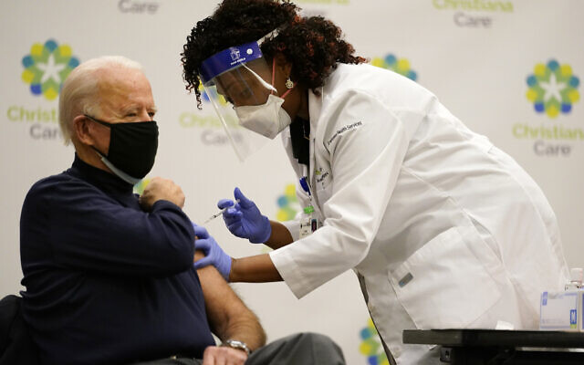US President-elect Joe Biden receives his first dose of the coronavirus vaccine at ChristianaCare Christiana Hospital in Newark, Delaware on December 21, 2020, from nurse practitioner Tabe Mase. (AP/Carolyn Kaster) US President-elect Joe Biden receives his first dose of the coronavirus vaccine at ChristianaCare Christiana Hospital in Newark, Delaware on December 21, 2020, from nurse practitioner Tabe Mase. (AP/Carolyn Kaster)
