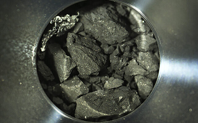 This optical microscope photo provided December 24, 2020, by the Japan Aerospace Exploration Agency (JAXA), shows soil samples, seen inside C compartment of the capsule brought back by Hayabusa2, in Sagamihara, near Tokyo. (JAXA via AP) This optical microscope photo provided December 24, 2020, by the Japan Aerospace Exploration Agency (JAXA), shows soil samples, seen inside C compartment of the capsule brought back by Hayabusa2, in Sagamihara, near Tokyo. (JAXA via AP)