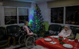 Two elderly people wait for Christmas eve dinner at an elderly care home in Pozuelo de Alarcon, outskirts of Madrid on Dec. 24, 2020. Many of the elderly in the residence haven't celebrated Christmas eve with their relatives to prevent the spread of coronavirus (AP/Bernat Armangue)