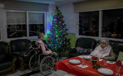 Two elderly people wait for Christmas eve dinner at an elderly care home in Pozuelo de Alarcon, outskirts of Madrid on Dec. 24, 2020. Many of the elderly in the residence haven't celebrated Christmas eve with their relatives to prevent the spread of coronavirus (AP/Bernat Armangue)
