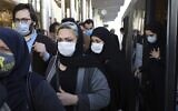 People wear protective face masks to help prevent the spread of the coronavirus in downtown Tehran, Iran. October 11, 2020. (AP Photo/Ebrahim Noroozi, File)