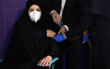 Tayebeh Mokhber is injected with the Coviran coronavirus vaccine produced by Shifa Pharmed, part of a state-owned pharmaceutical conglomerate, at a ceremony in Tehran, Iran, December 29, 2020. (AP Photo/Aref Taherkenareh)