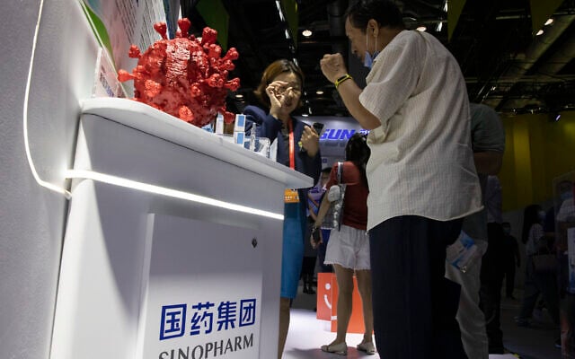 A promoter talks about the COVID-19 vaccine produced by Sinopharm subsidiary CNBG during a trade fair in Beijing on September 6, 2020. (Ng Han Guan/AP) A promoter talks about the COVID-19 vaccine produced by Sinopharm subsidiary CNBG during a trade fair in Beijing on September 6, 2020. (Ng Han Guan/AP)