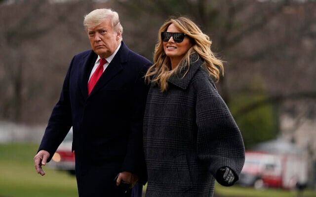 US President Donald Trump and first lady Melania Trump arrive on the South Lawn of the White House, December 31, 2020, in Washington. (AP Photo/Evan Vucci) US President Donald Trump and first lady Melania Trump arrive on the South Lawn of the White House, December 31, 2020, in Washington. (AP Photo/Evan Vucci)