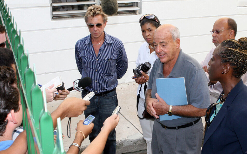 Pathologist Cyril Wecht, center, talks to the media while Bahamas' head coroner Linda Virgil, right, and attorney Michael Scott, left, listen, outside  the Rand Laboratory morgue at the Princess Margaret Hospital in Nassau, Bahamas, September 17, 2006. (AP Photo/Tim Aylen)