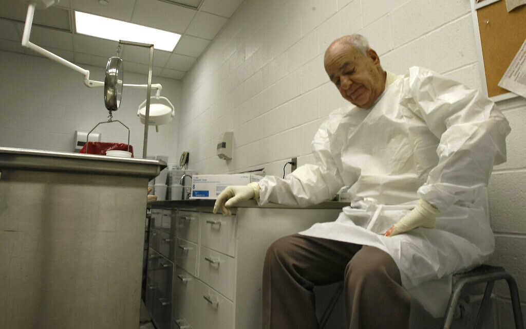 In this July 16, 2009 photo Dr. Cyril Wecht pauses as he records notes during an autopsy in Pittsburgh. (AP Photo/Keith Srakocic)