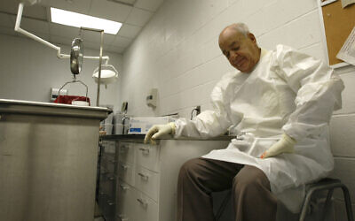 In this July 16, 2009 photo Dr. Cyril Wecht pauses as he records notes during an autopsy in Pittsburgh. (AP Photo/Keith Srakocic)
