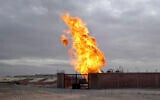 File: Flames are seen after an explosion at a gas terminal in Egypt's northern Sinai Peninsula on Saturday, Feb. 5, 2011 in El-Arish (AP Photo/Ashraf Swailem)