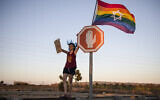 Illustrative: An Israeli woman from the LGBT community demonstrates against gay conversion therapy, in southern Israel, on July 14, 2019. (Tsafrir Abayov/AP)