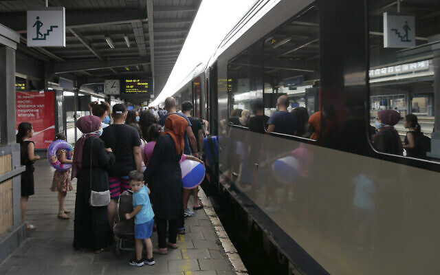 Illustrative: People wait to board a train in Brussels to the Belgian coastal resort of Blankenberge, Belgium on August 11, 2020. (AP Photo/Sylvain Plazy)