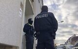 Illustrative: Police officers stand outside an apartment building during a search in Osnabrueck, Germany, November 6, 2020. (Festim Beqiri/TV7News/dpa via AP)