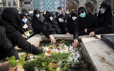 People pray at the grave of Mohsen Fakhrizadeh during his burial in Tehran, Iran, Nov. 30, 2020 (Hamed Malekpour/Tasnim News Agency via AP)