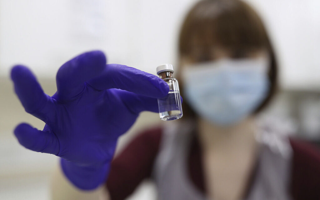 Illustrative: An NHS pharmacy technician at the Royal Free Hospital, simulates the preparation of the Pfizer vaccine to support staff training ahead of the rollout, in London, December 4, 2020. (Yui Mok/Pool Photo via AP)