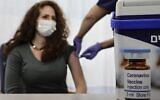 An Israeli nurse shows the media a simulated vaccination as part of the hospital's preparation for the coronavirus vaccinations, at the Sheba Tel Hashomer Hospital in Ramat Gan, December 10, 2020. (AP Photo/Sebastian Scheiner)