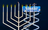 US Secretary of Interior David Bernhardt, center, joined by, from left, Rabbi Abraham Shemtov and Rabbi Levi Shemtov, light the National Hanukkah Menorah on The Ellipse, December 10, 2020 in Washington. (AP Photo/Manuel Balce Ceneta)