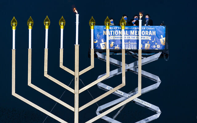 US Secretary of Interior David Bernhardt, center, joined by, from left, Rabbi Abraham Shemtov and Rabbi Levi Shemtov, light the National Hanukkah Menorah on The Ellipse, December 10, 2020 in Washington. (AP Photo/Manuel Balce Ceneta) US Secretary of Interior David Bernhardt, center, joined by, from left, Rabbi Abraham Shemtov and Rabbi Levi Shemtov, light the National Hanukkah Menorah on The Ellipse, December 10, 2020 in Washington. (AP Photo/Manuel Balce Ceneta)