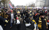 Supporters of US President Donald Trump wearing attire associated with the Proud Boys attend a rally at Freedom Plaza, December 12, 2020, in Washington. (AP Photo/Luis M. Alvarez)