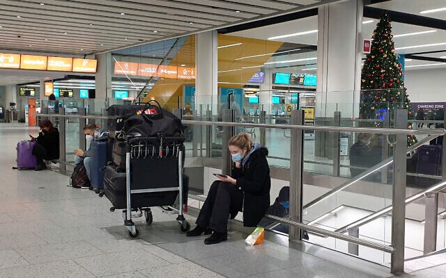 Passengers wait at Gatwick Airport in West Sussex, England, Dec. 20, 2020. One by one, several European Union nations have banned flights from the UK and others were considering similar action, in a bid to block a new strain of coronavirus sweeping across southern England from establishing a strong foothold on the continent. (Gareth Fuller/PA via AP) Passengers wait at Gatwick Airport in West Sussex, England, Dec. 20, 2020. One by one, several European Union nations have banned flights from the UK and others were considering similar action, in a bid to block a new strain of coronavirus sweeping across southern England from establishing a strong foothold on the continent. (Gareth Fuller/PA via AP)