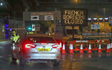 Police and port staff turn away a vehicle from the Port of Dover in Kent, England, which has been closed after France banned entry from the United Kingdom for 48 hours due to a new strain of the coronavirus, December 21, 2020. (Steve Parsons/PA via AP)