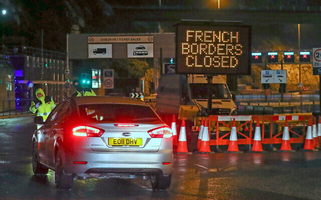 Police and port staff turn away a vehicle from the Port of Dover in Kent, England, which has been closed after France banned entry from the United Kingdom for 48 hours due to a new strain of the coronavirus, December 21, 2020. (Steve Parsons/PA via AP) Police and port staff turn away a vehicle from the Port of Dover in Kent, England, which has been closed after France banned entry from the United Kingdom for 48 hours due to a new strain of the coronavirus, December 21, 2020. (Steve Parsons/PA via AP)