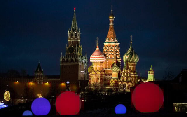 St. Basil Cathedral, right, and Kremlin's Spasskaya Tower, illuminated, as light balls are installed for New Year and Christmas celebrations in Zaryadye Park in Moscow, Russia, December 23, 2020. (Pavel Golovkin/ AP) St. Basil Cathedral, right, and Kremlin's Spasskaya Tower, illuminated, as light balls are installed for New Year and Christmas celebrations in Zaryadye Park in Moscow, Russia, December 23, 2020. (Pavel Golovkin/ AP)