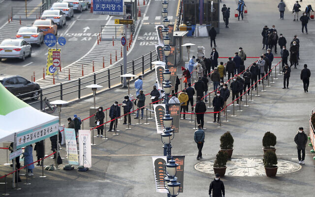 People queue in line to wait for coronavirus testing while maintaining social distancing at coronavirus testing site in Seoul, South Korea, Dec. 26, 2020. (Hong Hyosik/Newsis via AP) People queue in line to wait for coronavirus testing while maintaining social distancing at coronavirus testing site in Seoul, South Korea, Dec. 26, 2020. (Hong Hyosik/Newsis via AP)