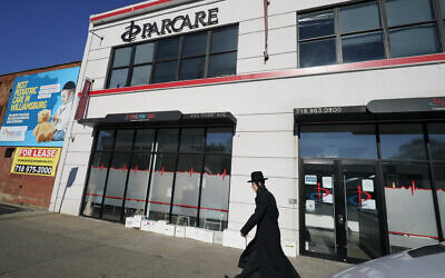 Illustrative: An Orthodox Jewish man walks past Parcare's health care facility, December 27, 2020, in the Willamsburg section of Brooklyn in New York. (AP Photo/Kathy Willens)