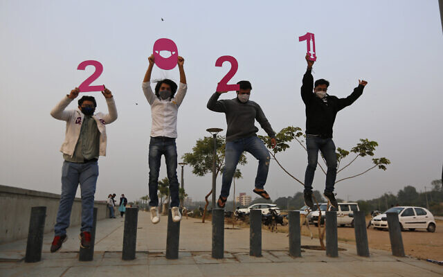 People hold cutouts to welcome the New Year in Ahmedabad, India, December 31, 2020. (AP Photo/Ajit Solanki) People hold cutouts to welcome the New Year in Ahmedabad, India, December 31, 2020. (AP Photo/Ajit Solanki)