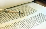 Illustrative: A pointer is used to follow the Hebrew written passages in the Torah. (AP Photo/ Rogelio Solis)