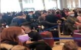 Screen capture from video showing crowding at Ben Gurion Airport, December 13, 2020. (Channel 12 news)