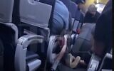 Screen capture from video showing passengers performing CPR on a man who collapsed with possible COVID-19 symptoms while on a United Airlines flight, December 14 2020. (YouTube)