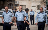 Commander of the Jerusalem District Police, Doron Yedid (C) seen in the Jerusalem neighborhood of Mea Shearim as police close shops and disperse public gatherings, March 30, 2020. (Yonatan Sindel/Flash90)