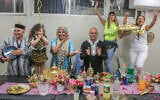 Members of the Ivgy family celebrate the Jewish Moroccan celebration of Mimouna, in the southern coastal city of Ashkelon, April 15, 2020. (Edi Israel/Flash90)
