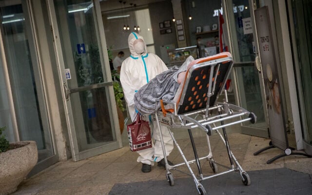 Magen David Adom worker at the coronavirus unit at the Hadassah Ein Karem hospital in Jerusalem on November 1, 2020 (Yonatan Sindel/Flash90) Magen David Adom worker at the coronavirus unit at the Hadassah Ein Karem hospital in Jerusalem on November 1, 2020 (Yonatan Sindel/Flash90)