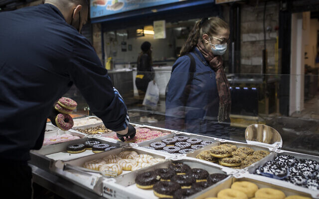 'Sufganiyot' donuts sold at a bakery in the Mahane Yehuda Market, Jerusalem, ahead of the Jewish holiday of Hanukkah, on November 26, 2020. (Hadas Parush/Flash90) 'Sufganiyot' donuts sold at a bakery in the Mahane Yehuda Market, Jerusalem, ahead of the Jewish holiday of Hanukkah, on November 26, 2020. (Hadas Parush/Flash90)