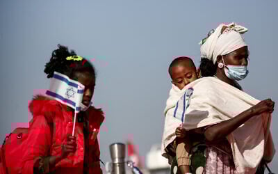 Members of the Ethiopian Jewish community arrive at  Ben Gurion airport, outside Tel Aviv, on December 3, 2020. (Miriam Alster/Flash90)