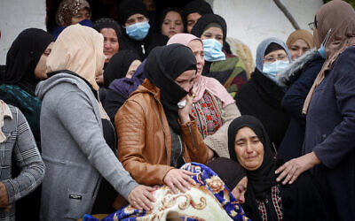 The family of Palestinian teenager Ali Abu Aliya mourns during his funeral in the village of al-Mughayyir near Ramallah in the central West Bank on December 5, 2020. (Nasser Ishtayeh/Flash90)