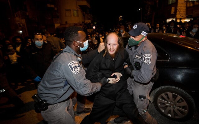 Ultra-Orthodox Jewish men scuffle with Israeli police as they protest against the new contractions work for the Jerusalem Light Rail, December 7, 2020. (Yonatan Sindel/Flash90) Ultra-Orthodox Jewish men scuffle with Israeli police as they protest against the new contractions work for the Jerusalem Light Rail, December 7, 2020. (Yonatan Sindel/Flash90)