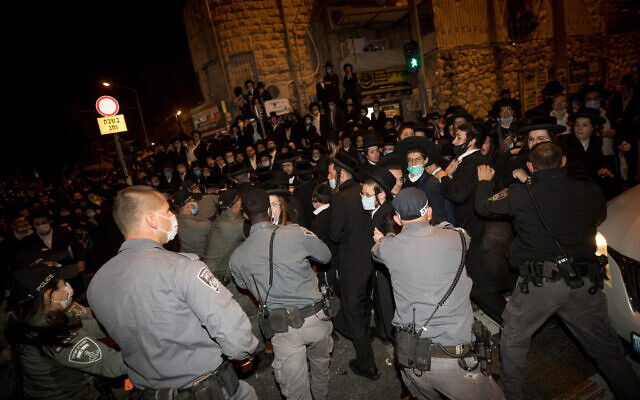 Ultra-Orthodox Jewish men scuffle with Israeli police as they protest against the new contractions work for the Jerusalem Light Rail, December 7, 2020. (Yonatan Sindel/Flash90) Ultra-Orthodox Jewish men scuffle with Israeli police as they protest against the new contractions work for the Jerusalem Light Rail, December 7, 2020. (Yonatan Sindel/Flash90)