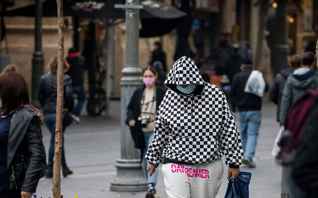 Illustrative: People wearing face masks walk on Jaffa Street in downtown Jerusalem on December 7, 2020. (Yonatan Sindel/Flash90) Illustrative: People wearing face masks walk on Jaffa Street in downtown Jerusalem on December 7, 2020. (Yonatan Sindel/Flash90)