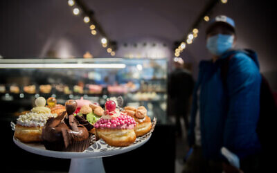 Israeli donuts sold at the Roladin bakery ahead of the Jewish holiday of Hanukkah, outside the Mahane Yehuda market in Jerusalem, on December 7, 2020. (Yonatan Sindel/Flash90)