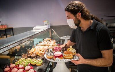 Sufganiyot donuts sold at a bakery ahead of Hanukkah, outside the Mahane Yehuda Market in Jerusalem, on December 7, 2020 (Yonatan Sindel/Flash90)