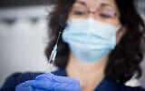 An Israeli nurse seen during a simulated vaccination against the coronavirus, at Sheba Medical Center in Ramat Gan. (Miriam Alster/Flash90)