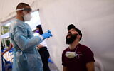 Health care workers test Israelis for coronavirus at Rabin Square in Tel Aviv on December 10, 2020. (Tomer Neuberg/Flash90)