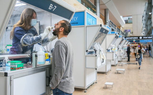 A technician collects nasal swab samples for COVID-19 at the coronavirus lab, at Ben-Gurion International Airport on December 14, 2020. (Yossi Aloni/Flash90) A technician collects nasal swab samples for COVID-19 at the coronavirus lab, at Ben-Gurion International Airport on December 14, 2020. (Yossi Aloni/Flash90)