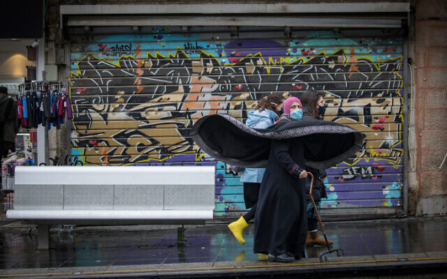 People walk in Jerusalem on December 16, 2020. (Olivier Fitoussi/Flash90) People walk in Jerusalem on December 16, 2020. (Olivier Fitoussi/Flash90)